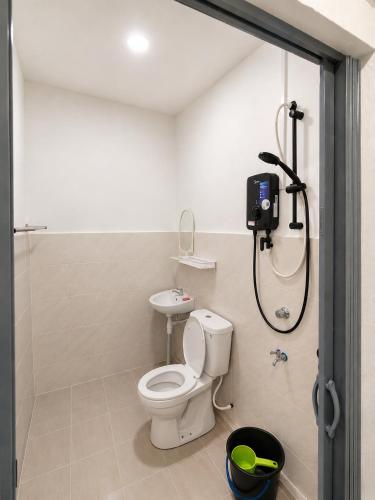 a bathroom with a shower with a toilet and a sink at TBSC by Reemon in Keningau