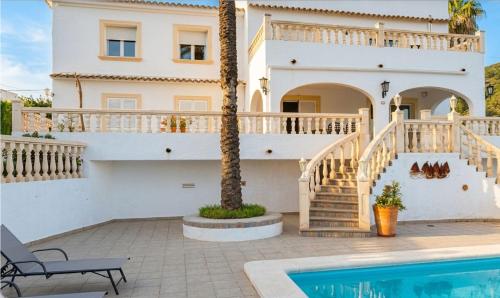 a villa with a swimming pool and a house at Vista Portet, sleeps 10, Private Pool, Sea Views, Squash, 1 km from El Portet beach in Teulada