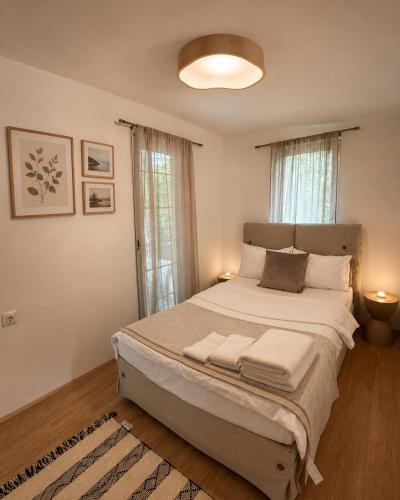 a bedroom with a large bed with two lamps at Casa Matthias in Kavadarci