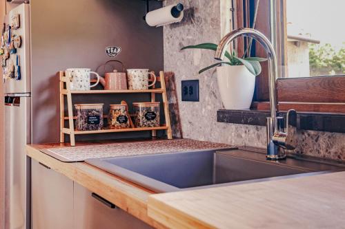 a kitchen with a sink and a counter with cups at Museum Draginë-Guest House in Sukobin