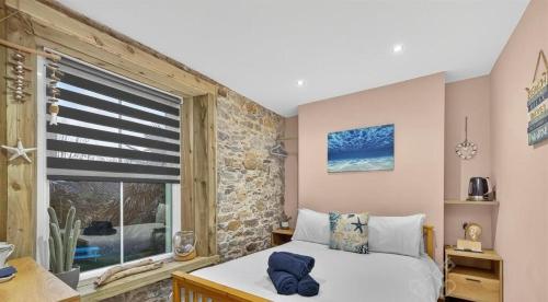 a bedroom with a bed and a window at Island Lodge A relaxed Boutique stay tucked into Plymouth historic Barbican combining spacious modern rooms with warm hospitality in Plymouth