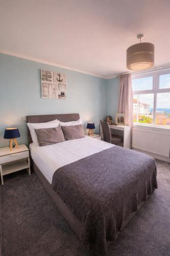 a bedroom with a large bed and a window at The Lyncroft in Newquay