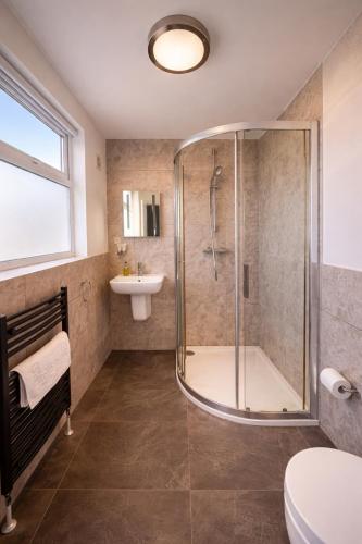 a bathroom with a shower and a sink at The Lyncroft in Newquay