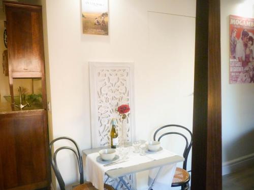 a white table with chairs and a vase of flowers on it at Teatrisso Hotel Palacio in Cuzcurrita-Río Tirón