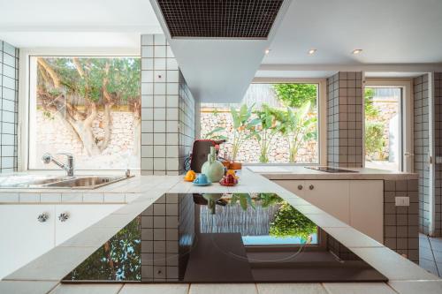 a kitchen with a large window and a sink at MareLuxe & Pool - Villa By The Sea in Polignano a Mare