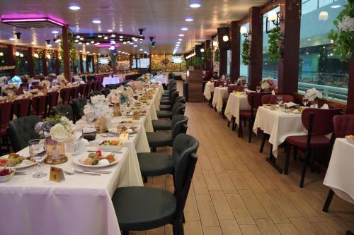 a row of tables in a restaurant with white table linen at Bosphorus Tour Organization in Istanbul