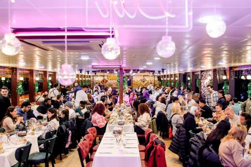a group of people sitting at tables in a banquet hall at Bosphorus Tour Organization in Istanbul