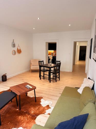a living room with a couch and a table at Le Commerce-Gare-Centre-Ville in Montbéliard