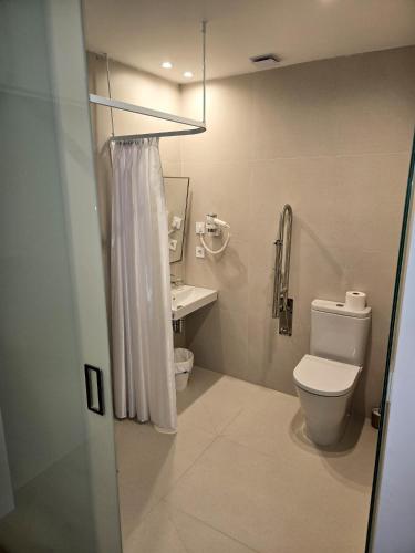 a bathroom with a toilet and a sink at B&H Boreal in Burgos