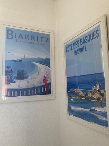 two posters are hanging on a wall at Domaine du Malda Côte Basque in Anglet