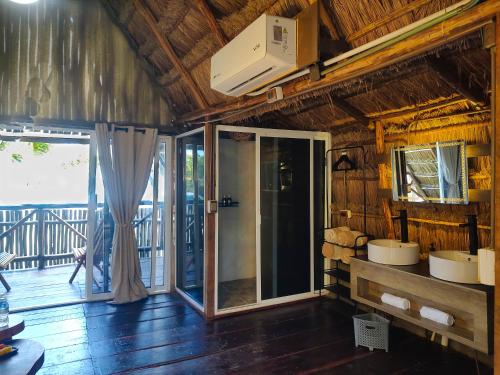 a bathroom with two sinks in a room with a balcony at Hotel Boutique Sylvie in Mahahual