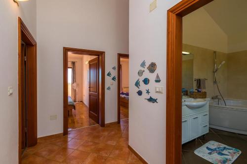 a bathroom with a sink and a toilet and a mirror at Villa Antonela in Divšići