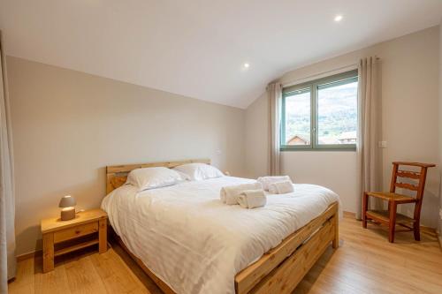 a bedroom with a large bed with towels on it at Villa Mareyland Saint-Jorioz, in Saint-Jorioz