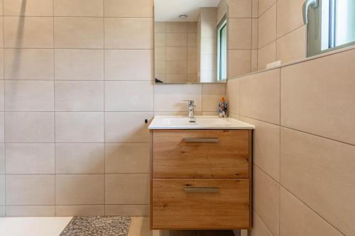 a bathroom with a sink and a mirror at Villa Mareyland Saint-Jorioz, in Saint-Jorioz