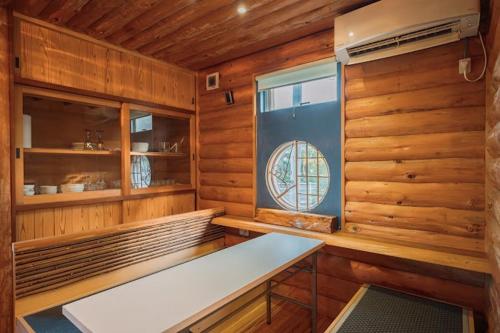 a room with a bench in a wooden room at AJITO Chigasaki in Chigasaki