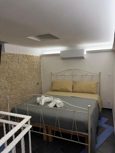 a bed with a metal frame in a room at B&B Fiore di Maggio in Mola di Bari