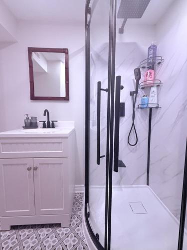 a white bathroom with a shower and a sink at Large Private Suit With Free Parking in Mississauga