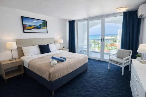 a hotel room with a bed and a balcony at Relaxing Ocean View Condo by the Beach in San Juan