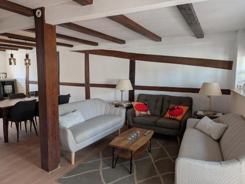 a living room with two couches and a table at Ferienhaus Wallkieker in Boizenburg