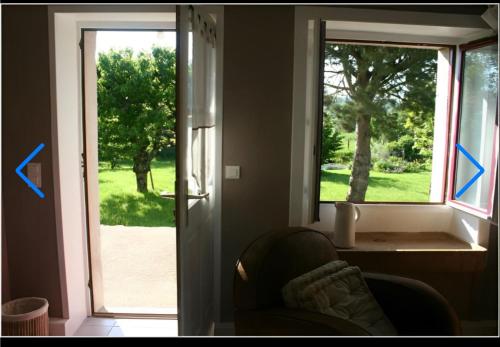 a room with a door and a window and a chair at Chambre d'hôtes beau rivage in Falletans