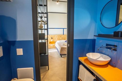 a bathroom with a sink and a blue wall at Fantini Club Hotel in Cervia