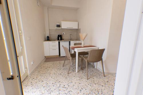 a small kitchen with a table and chairs at Civico Dodici in Modica