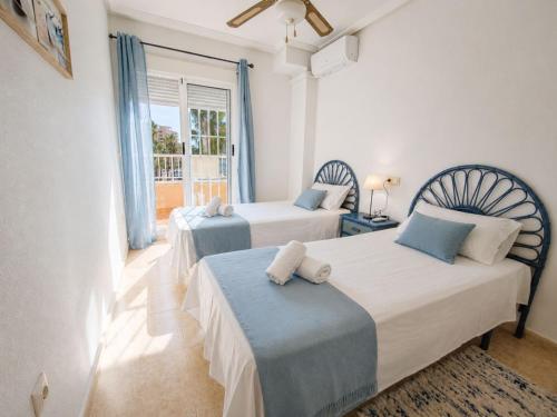 a bedroom with two beds and a window at Dream house with Sea Views in La Mata Beach in Torrevieja