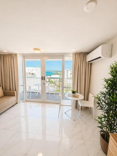 a living room with a view of the ocean at Oceanview Beach Condo in Prime Location in San Juan