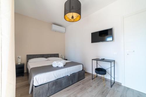 a bedroom with a bed and a table and a tv at Casa a due passi dal mare in Alba Adriatica