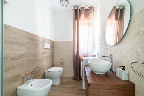 a bathroom with a sink and a toilet and a mirror at Casa a due passi dal mare in Alba Adriatica