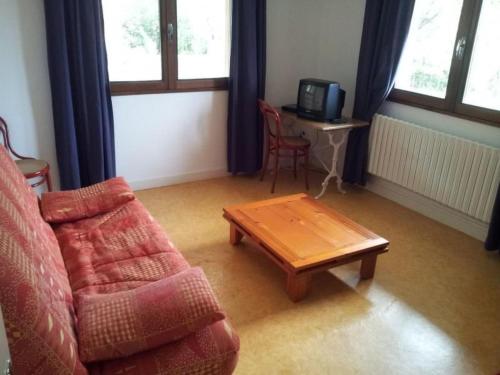 a living room with a couch and a coffee table at Apartment mit Gemeinschaftspool im Diois by Interhome in Die