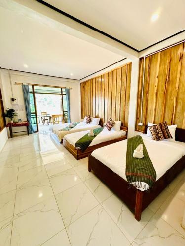 a bedroom with two beds in a room at Views Backpackers Hostel in Nongkhiaw