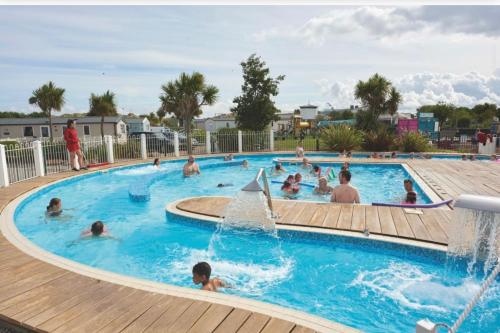 a group of people in a swimming pool at a resort at Lifes a Beach on Presthaven Sands in Prestatyn