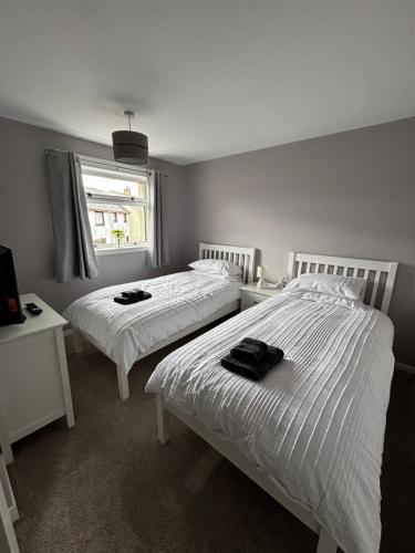 a bedroom with two beds and a window at Caol Mountain View in Caol
