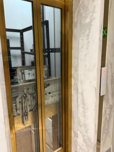 a glass door in a room with a window at Mb View taj in Tājganj