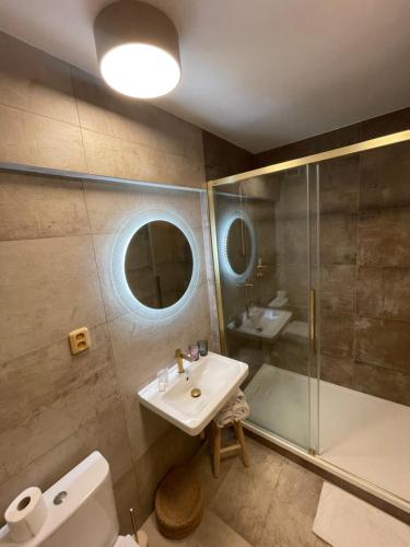 a bathroom with a sink and a shower at Bonato Hotel in Náchod