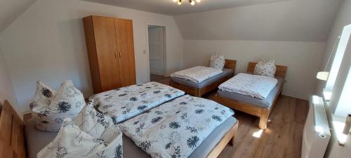 a small room with two beds and a cabinet at Hirschhäusl in Großschönau