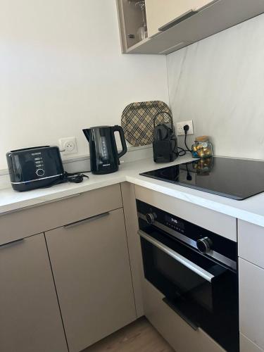 a kitchen with a stove and a counter top at chambre avec terrasse et coin repas in Ciboure