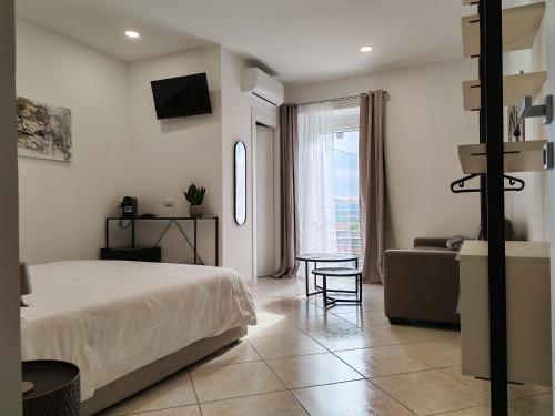 a bedroom with a bed and a couch and a table at Silia's Place rooms & breakfast in Ripi