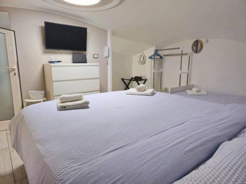 a bedroom with a large bed with towels on it at TERRA HOME Gaeta - Moderno Bilocale nel Borgo in Gaeta