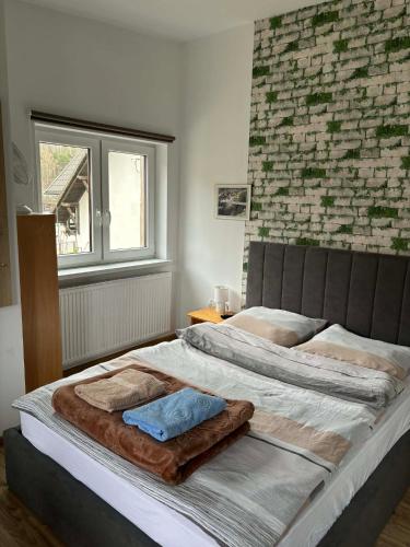 a large bed with a blanket on it in a bedroom at Pokoje U Anny i Łukasza in Swornegacie