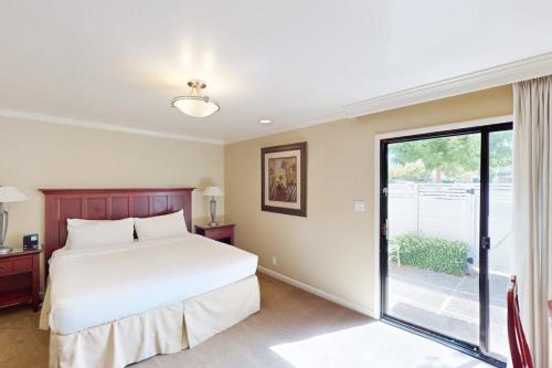 a bedroom with a bed and a sliding glass door at Silverado Resort and Spa 374 & 375 in Napa