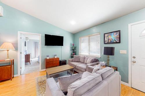 a living room with a couch and a flat screen tv at Old River Hideaway in Guerneville