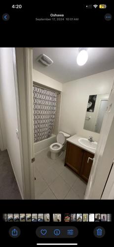 a bathroom with a toilet and a sink at Relax Guest House in Oshawa
