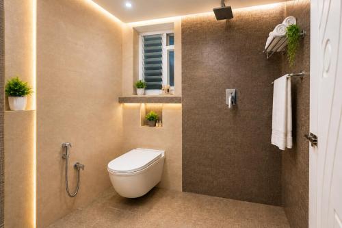 a bathroom with a toilet and a shower at Urban Comforts - Near US Consulate Business Hotel in T Nagar in Chennai