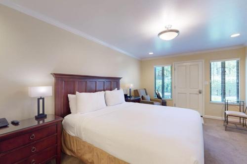 a bedroom with a large white bed and a desk at Silverado Resort and Spa 375 in Napa