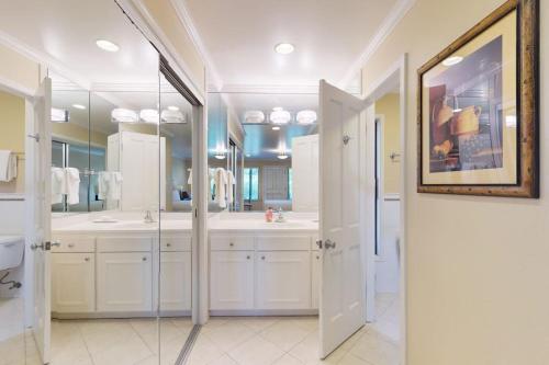 a bathroom with two sinks and two mirrors at Silverado Resort and Spa 375 in Napa