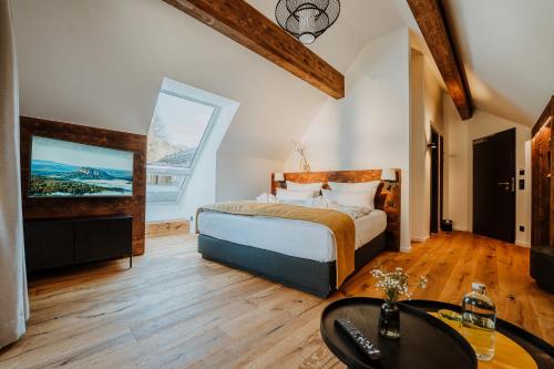 a bedroom with a bed and a large window at WALDGUT Naturresort in Bad Gottleuba