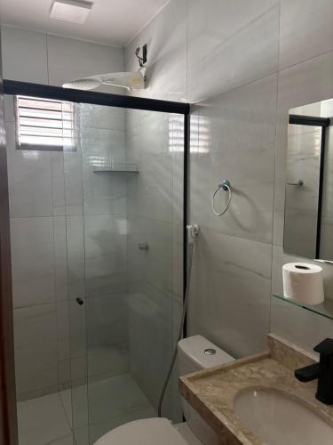 a bathroom with a shower and a toilet and a sink at Hotel pousada czar in João Pessoa