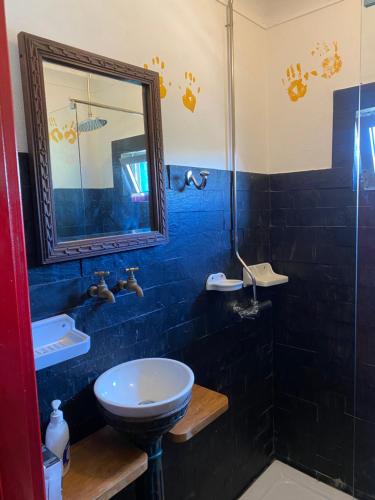 a bathroom with a sink and a toilet and a mirror at Casa S. Nicolau in Cabeceiras de Basto
